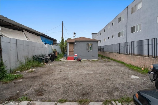view of vehicle parking featuring entry steps and a fenced backyard