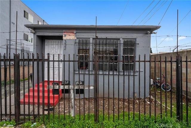 view of gate featuring a fenced front yard
