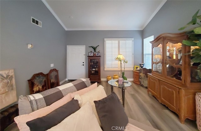 11102 Avolencia Pl, Garden Grove, CA 92840 - living area featuring vaulted ceiling, crown molding, light wood-style floors, and baseboards