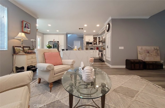 11102 Avolencia Pl, Garden Grove, CA 92840 - living room featuring light wood-type flooring, crown molding, recessed lighting, and baseboards