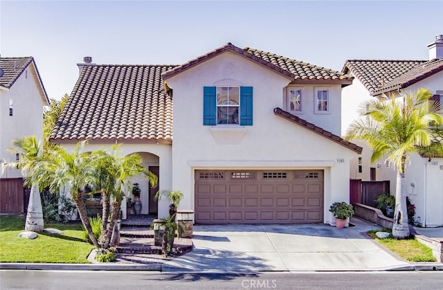 11102 Avolencia Pl, Garden Grove, CA 92840 - mediterranean / spanish house with driveway, a tile roof, stucco siding, and a garage
