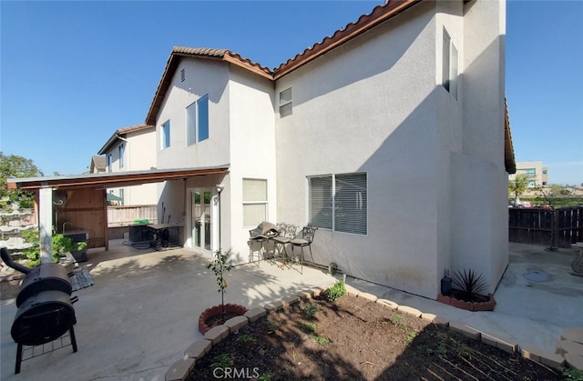 11102 Avolencia Pl, Garden Grove, CA 92840 - back of property with stucco siding, a tile roof, and a patio area