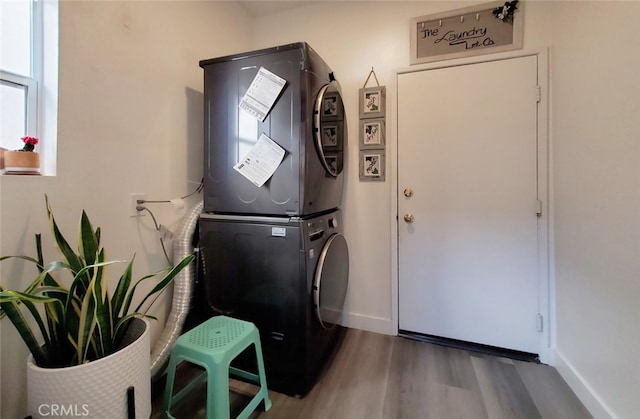11102 Avolencia Pl, Garden Grove, CA 92840 - laundry room with stacked washer / drying machine, wood finished floors, and baseboards