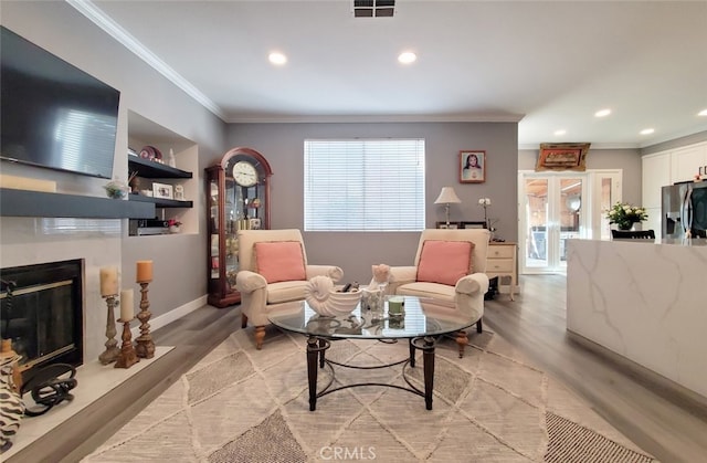 11102 Avolencia Pl, Garden Grove, CA 92840 - living area with ornamental molding, light wood finished floors, recessed lighting, a fireplace, and baseboards