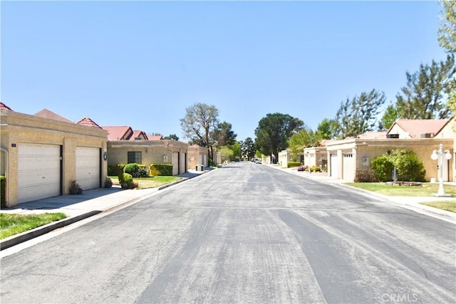 view of street featuring a residential view and curbs