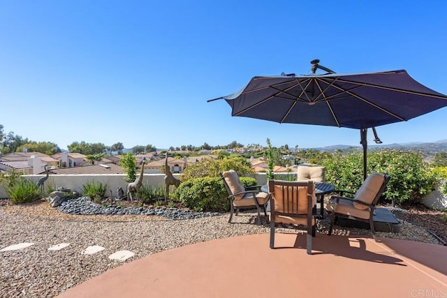 view of patio featuring outdoor dining area and fence