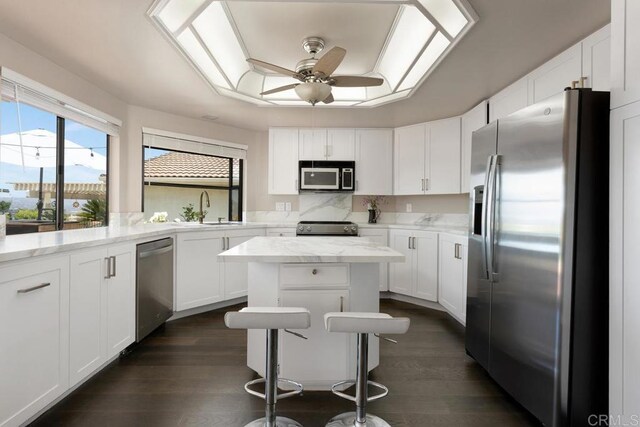 13336 Corte De Comares, San Diego, CA 92128 - kitchen with appliances with stainless steel finishes, white cabinetry, a ceiling fan, and dark wood-style floors