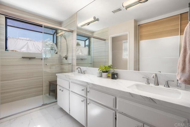 13336 Corte De Comares, San Diego, CA 92128 - bathroom featuring marble finish flooring, double vanity, and a stall shower