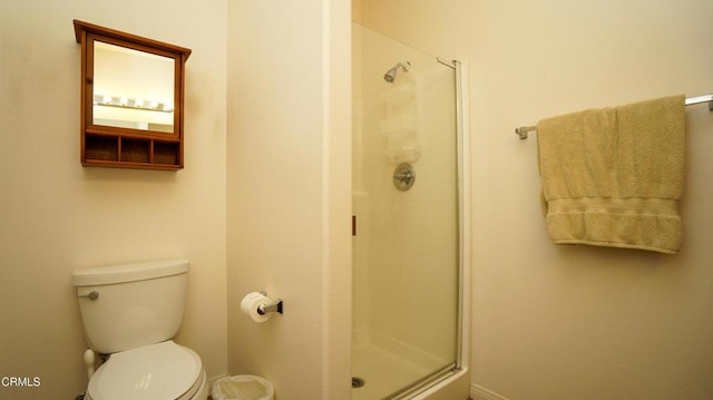 full bath with a stall shower and toilet