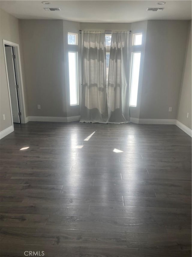2821 Carnoustie, Ontario, CA 91761 - empty room with visible vents, baseboards, and dark wood finished floors