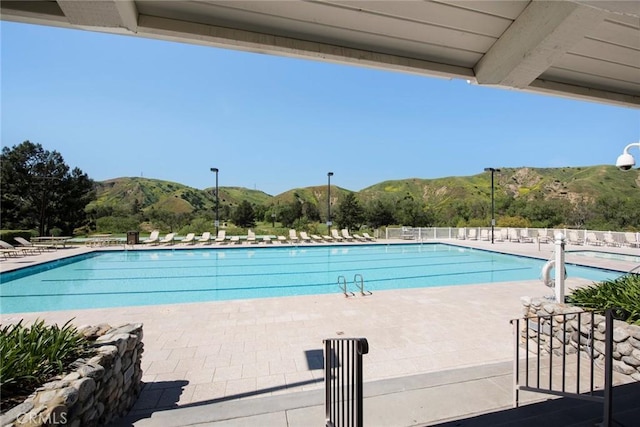 pool featuring a mountain view and a patio area