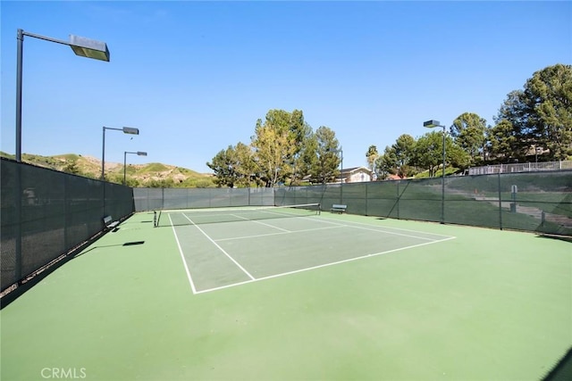 view of tennis court with fence