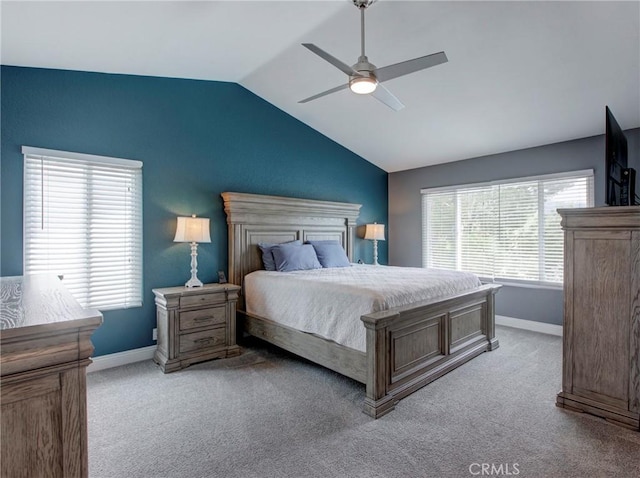 bedroom featuring lofted ceiling, light colored carpet, a ceiling fan, and baseboards
