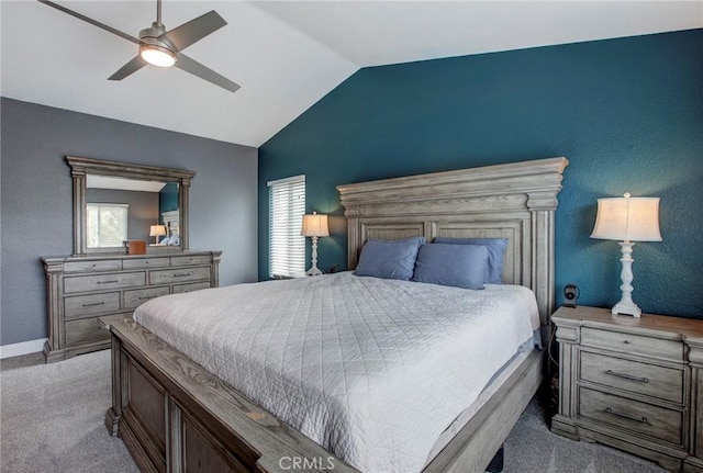 carpeted bedroom featuring lofted ceiling, ceiling fan, and baseboards