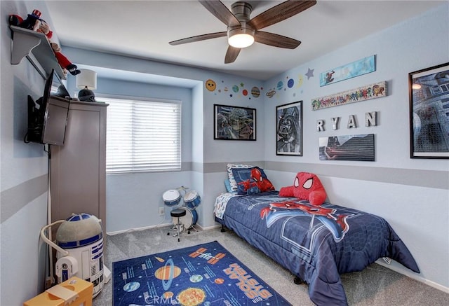 carpeted bedroom featuring a ceiling fan and baseboards