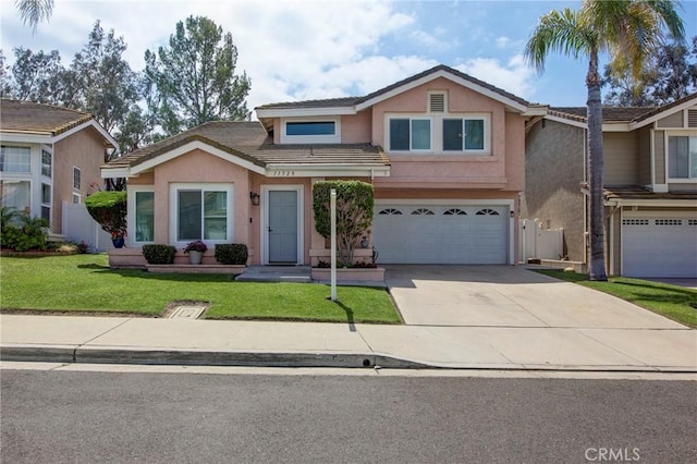 traditional home with concrete driveway, a garage, stucco siding, and a tiled roof