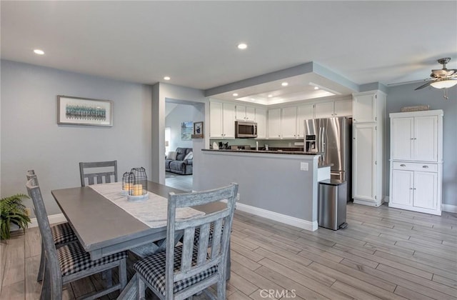 dining room with recessed lighting, a ceiling fan, and light wood-style floors