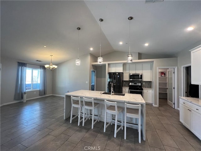 17238 Danbury Ave, Hesperia, CA 92345 - kitchen with white cabinetry, tasteful backsplash, an inviting chandelier, a sink, and appliances with stainless steel finishes