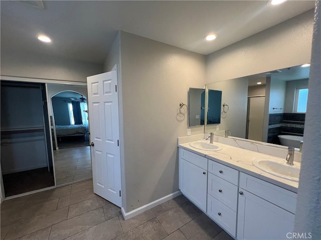 17238 Danbury Ave, Hesperia, CA 92345 - ensuite bathroom with double vanity, a sink, a stall shower, and baseboards