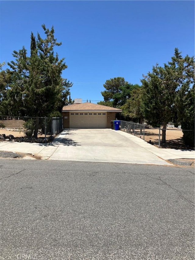 56707 Desert Gold Dr, Yucca Valley, CA 92284 - view of property hidden behind natural elements with driveway and a garage