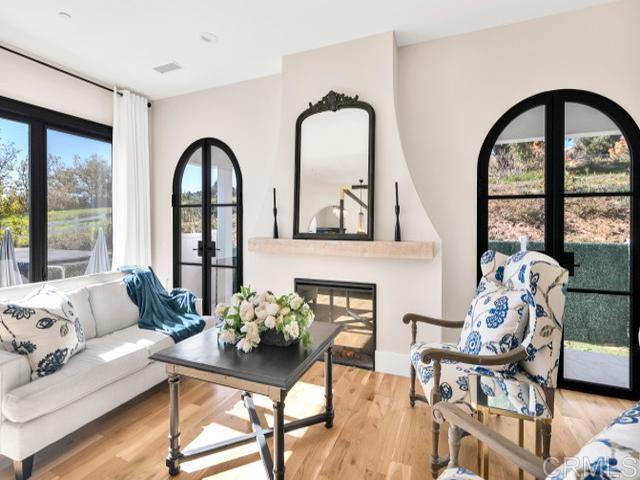 2255 Via Dulcea, Fallbrook, CA 92028 - living area with french doors, a glass covered fireplace, and wood finished floors