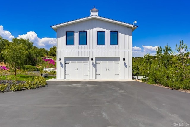 2255 Via Dulcea, Fallbrook, CA 92028 - view of front of home featuring board and batten siding, a garage, and asphalt driveway