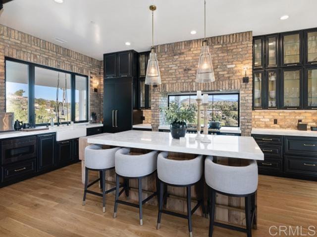2255 Via Dulcea, Fallbrook, CA 92028 - kitchen featuring dark cabinets, light countertops, a breakfast bar area, and recessed lighting