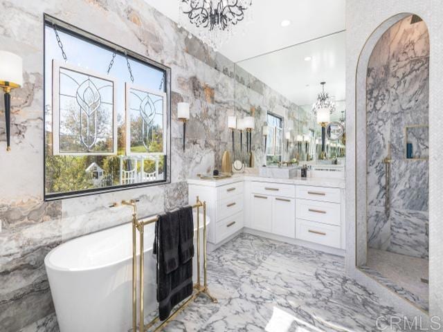 2255 Via Dulcea, Fallbrook, CA 92028 - bathroom with a chandelier, marble tiled flooring, vanity, a freestanding tub, and a marble finish shower