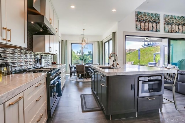 2255 Via Dulcea, Fallbrook, CA 92028 - kitchen featuring range with gas stovetop, wall chimney exhaust hood, healthy amount of natural light, oven, and recessed lighting