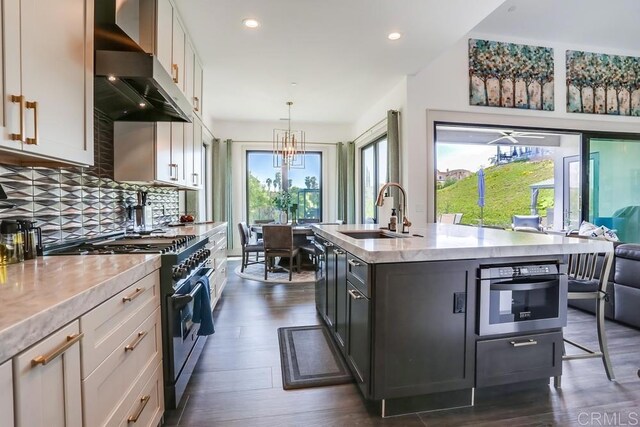 2255 Via Dulcea, Fallbrook, CA 92028 - kitchen featuring range with gas stovetop, wall chimney exhaust hood, healthy amount of natural light, oven, and recessed lighting