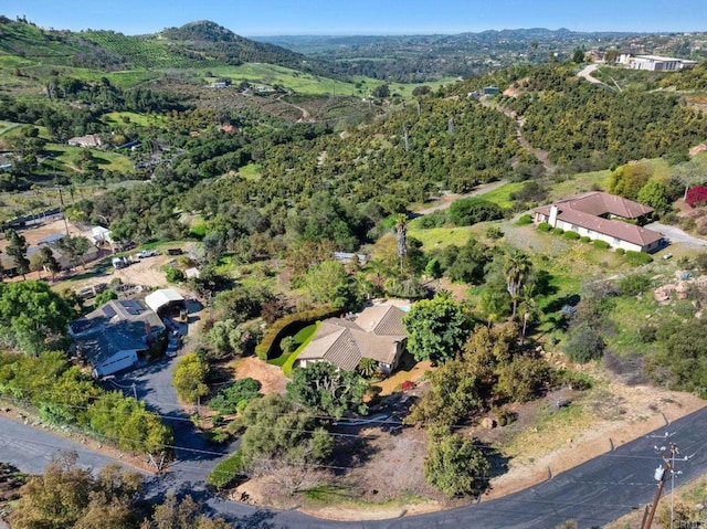 birds eye view of property featuring a wooded view