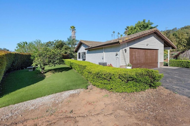 view of property exterior with a lawn