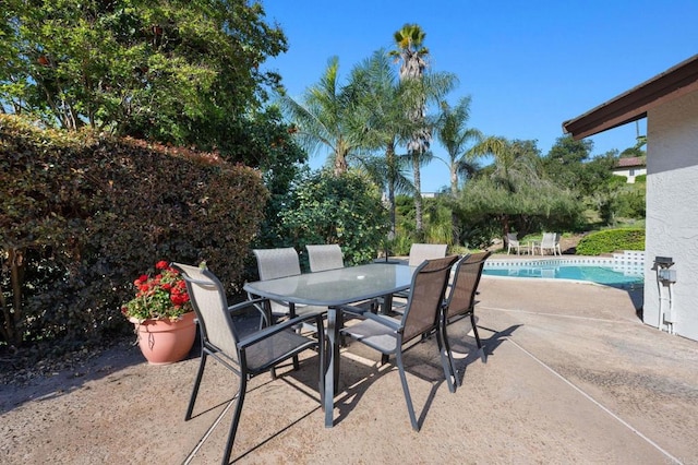 view of patio featuring an outdoor pool and outdoor dining area