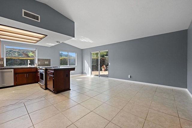 kitchen featuring visible vents, appliances with stainless steel finishes, light tile patterned flooring, and lofted ceiling