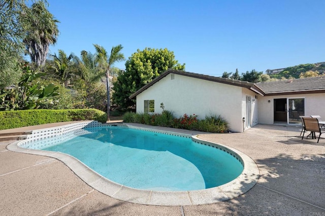 outdoor pool with a patio area