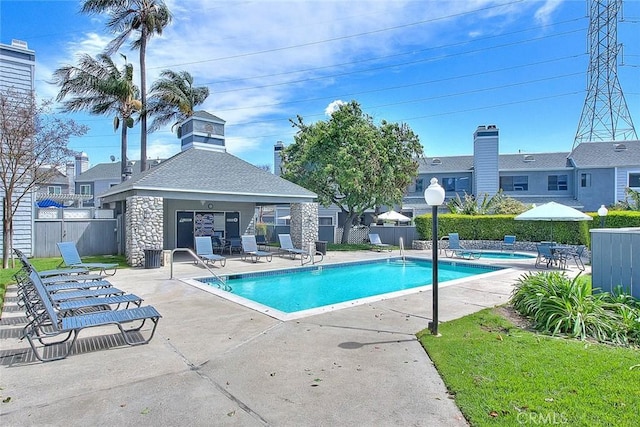 pool featuring a patio and fence