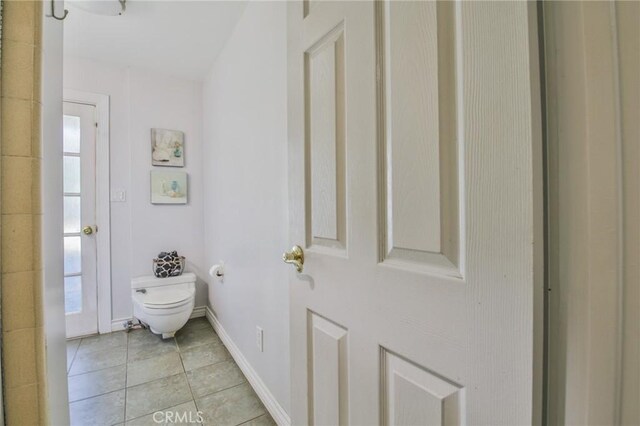 13720 Woodcock Ave, Sylmar, CA 91342 - bathroom featuring toilet, tile patterned flooring, plenty of natural light, and baseboards