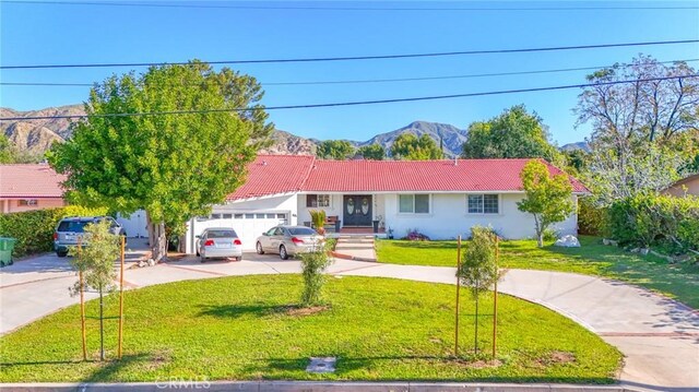 13720 Woodcock Ave, Sylmar, CA 91342 - ranch-style house with concrete driveway, a tiled roof, a front yard, an attached garage, and a mountain view