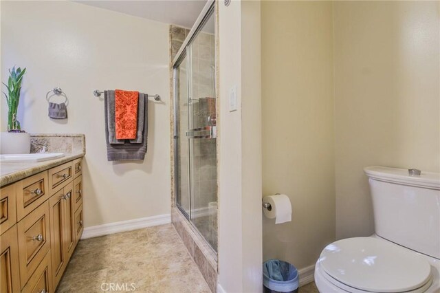13720 Woodcock Ave, Sylmar, CA 91342 - bathroom with toilet, a stall shower, vanity, and baseboards