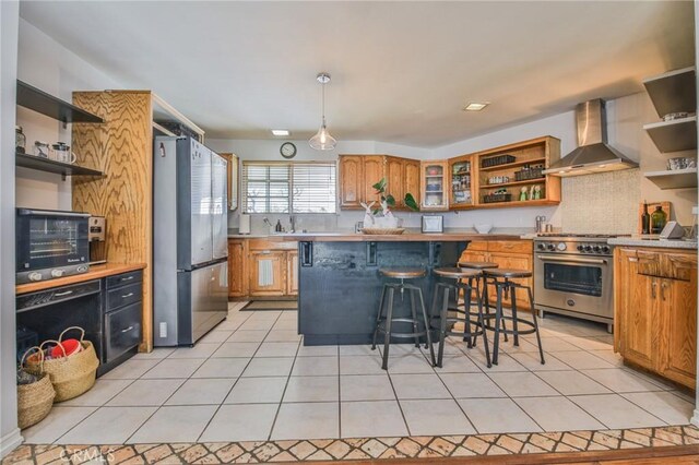 13720 Woodcock Ave, Sylmar, CA 91342 - kitchen with open shelves, appliances with stainless steel finishes, wall chimney range hood, and light countertops