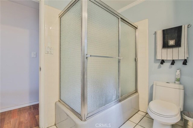 13720 Woodcock Ave, Sylmar, CA 91342 - full bathroom featuring toilet, shower / bath combination with glass door, crown molding, and wood finished floors