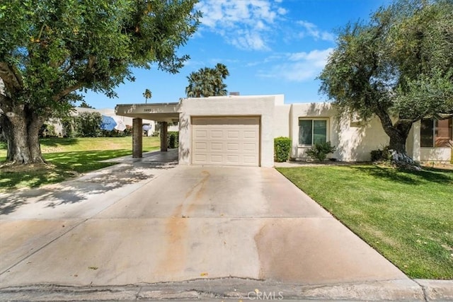 1692 Fairway Cir, Palm Springs, CA 92264 - pueblo-style house with a front lawn, driveway, an attached carport, a garage, and stucco siding