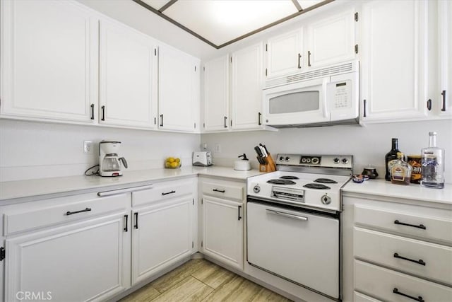 1692 Fairway Cir, Palm Springs, CA 92264 - kitchen with light countertops, light wood-style floors, white cabinetry, and white appliances