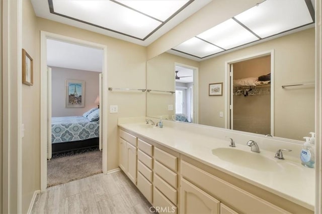 1692 Fairway Cir, Palm Springs, CA 92264 - bathroom featuring double vanity, wood finished floors, ensuite bathroom, and a sink
