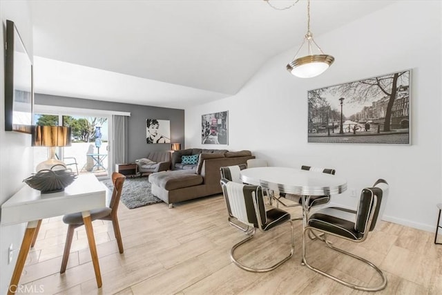 1692 Fairway Cir, Palm Springs, CA 92264 - dining space featuring wood finished floors, lofted ceiling, and baseboards