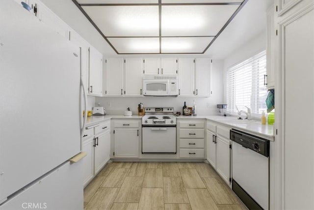 1692 Fairway Cir, Palm Springs, CA 92264 - kitchen with white cabinets, a sink, white appliances, and light countertops