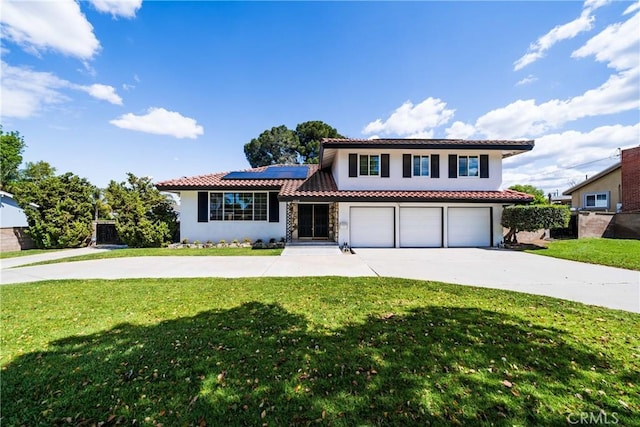 view of front of house with a front lawn, solar panels, driveway, and stucco siding