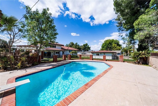 view of swimming pool with a patio area, fence, and a fenced in pool