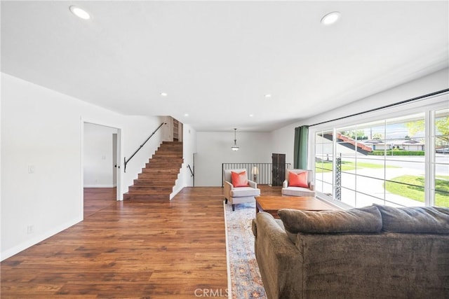 living room with recessed lighting, stairway, baseboards, and wood finished floors