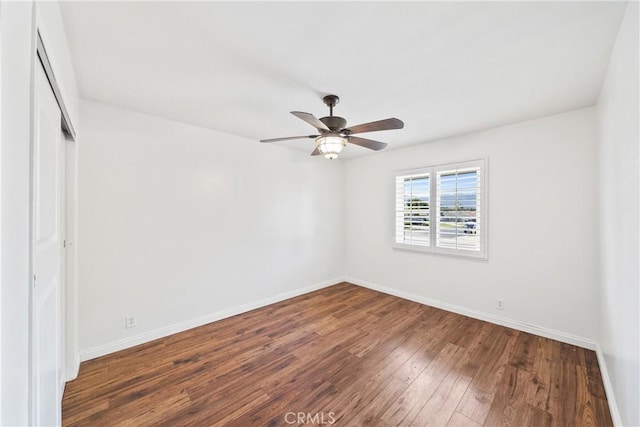 unfurnished room featuring baseboards, a ceiling fan, and wood finished floors